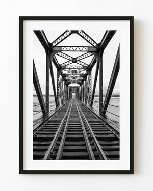 Black and white railway bridge in Quebec with centered vanishing point