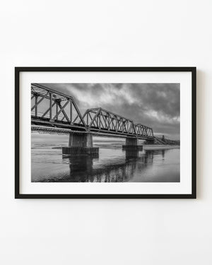 Moody sky over Quebec train bridge