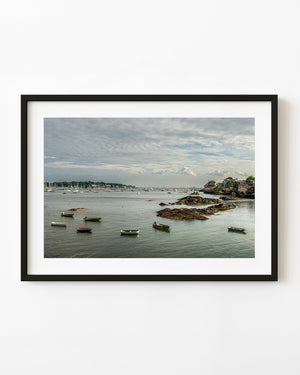Small boats anchored beside rocky shores in a quiet Massachusetts harbour
