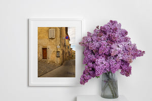 Old stone road and rustic building facade in a quiet Tuscany town