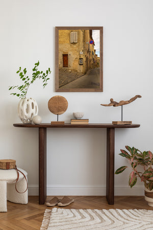 Historic Tuscany alleyway with street sign and aged plaster buildings