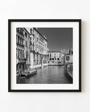 Black and white photo of Venice canal with historic buildings