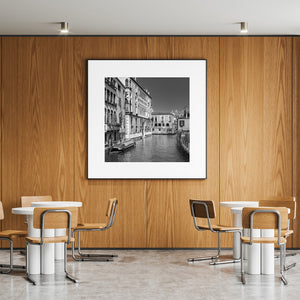 Daytime black and white view of Venice canal and buildings