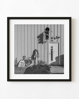 Quirky Route 66 workshop entrance with a traffic light and mannequin in black and white