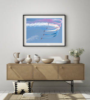 Red and white smoke looping above a Red Arrows formation