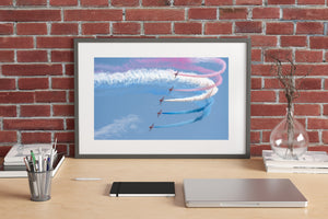 Colour aviation photograph of the Red Arrows performing a coordinated turn