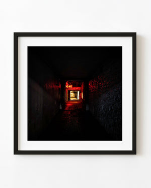 Red neon Art sign glowing in a dark stone-walled laneway