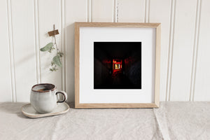 Stone wall catching red neon light deep inside a narrow alley