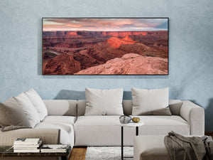 Warm evening light catching a pointed canyon butte