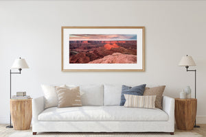 Wide canyon landscape with layered cliffs and a rocky foreground