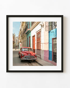 Red vintage Chevrolet parked on a Havana street