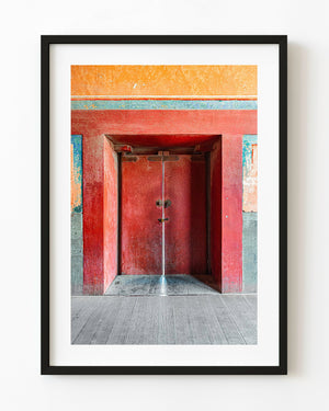 Weathered red doors in the Forbidden City with a narrow line of light between them