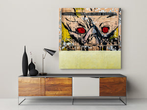 Square photograph of a red-eyed alien mural on cracked painted plaster