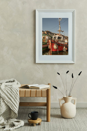 Vertical colour photograph of an old red fishing boat in Cobh harbour