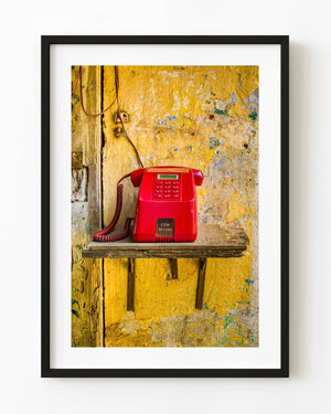Red payphone on broken shelf