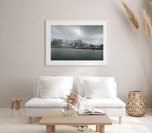 Norwegian cabins on wooden stilts above smooth grey water