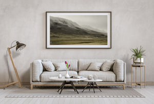 Iceland landscape with winding stream and distant rural farm