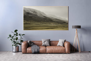 Remote Iceland valley with red roof houses and mountain fog