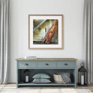 Picturesque red rowboat against a backdrop of aged wall