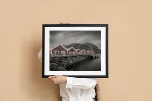 Rocky Norwegian shoreline with waterfront fishing cabins