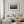 Row of red wooden cabins beside calm harbor water