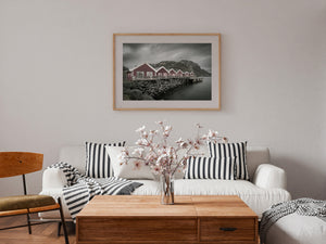 Desaturated coastal photograph with muted red cabins