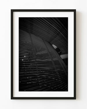 Curving horizontal lines inside Berlin’s Reichstag dome in black and white
