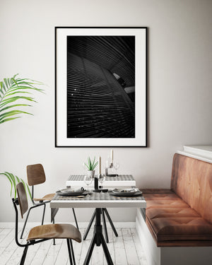 Monochrome view of curved architectural layers and small starburst lights