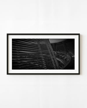 Curving metal slats and glass railing inside Berlin’s Reichstag dome in black and white