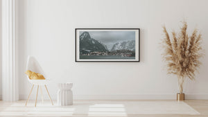 Norwegian fishing village clustered at the foot of dramatic Lofoten mountains