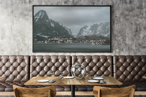 Muted evening landscape of Reine village and snowy mountains in Lofoten