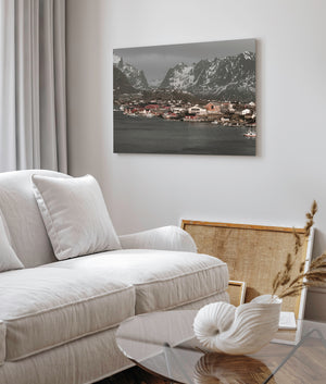 Norwegian coastal village with muted red houses and dark harbour water