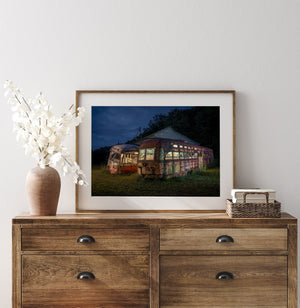 Eerie silhouette of a line of abandoned trolleys at dusk, their outlines ghostly reminders of a bygone era of transit.