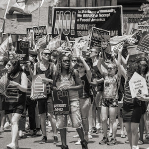 people marching with protest signs in New York