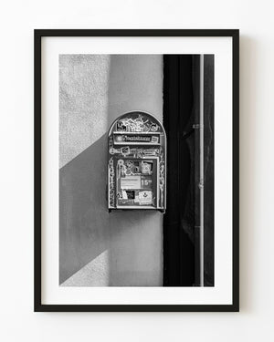 Graffiti covered mailbox mounted on Reykjavik wall in black and white