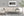 Ruined Irish cottage with a corrugated roof and dense undergrowth
