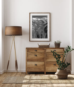 Steep mountain ridges surrounding dense evergreen forest