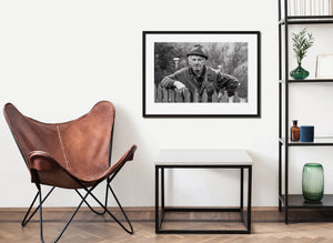 close portrait of older man in rural Romania wearing hat and work coat