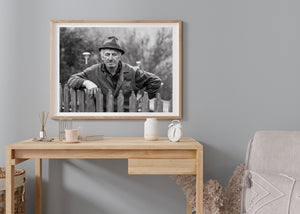 black and white image of farmer with weathered face in Romanian countryside