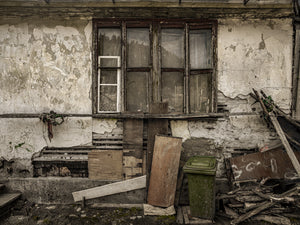 Weathered wooden window frame on rural Romanian wall