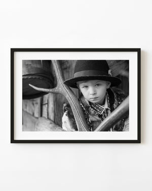 Young Romanian boy in traditional handmade clothing in black and white