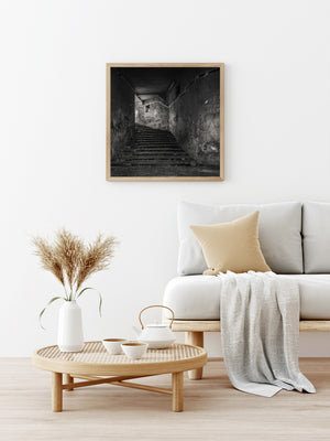 Weathered plaster and exposed brick around a Romanian stairway