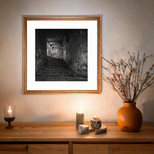Monochrome architectural scene with worn stairs and scratched walls