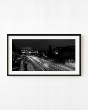 Rome Colosseum at night with sweeping traffic light trails