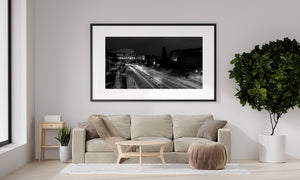 Monochrome night photograph of Rome with bright road traffic trails