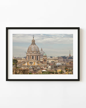 Rome church domes rising above layered Italian rooftops
