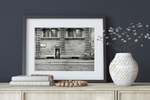 Woman waiting with bicycles along a textured Roman wall
