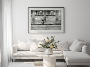 Monochrome street photograph with tall windows and cobbled paving in Rome