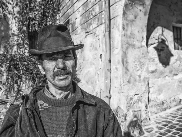 Romanian man standing by old building