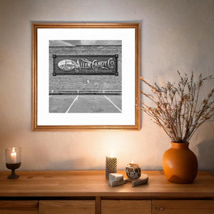 Brick wall with restored Allen Candy sign on Route 66